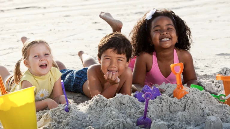 Kids play with beach toys close to beach their Nantucket home